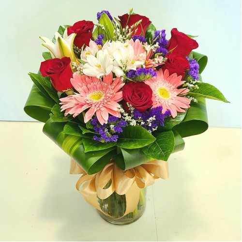 Orange Gerberas And Seasonal Flowers In A Vase